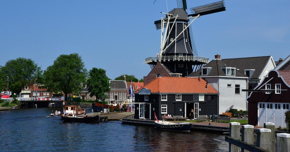 Windmill De Adriaan standing beside the Spaarne river in Haarlem