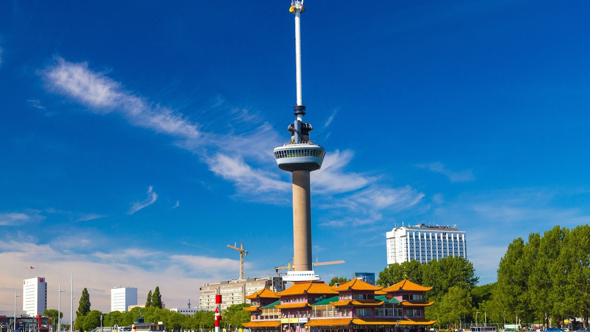 The Euromast observation tower rising above the trees of Rotterdam under a clear blue sky